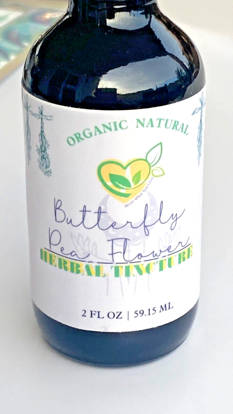 Butterfly pea flower tincture preparation image, blue herbal extract drop in water