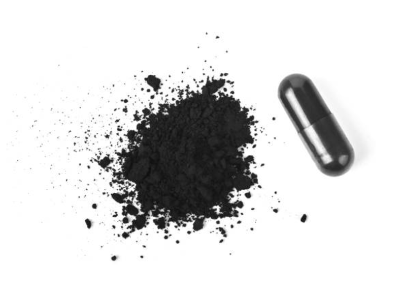 Black powder and a black capsule on a white background