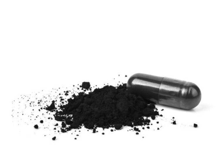 Black powder and a black capsule on a white background